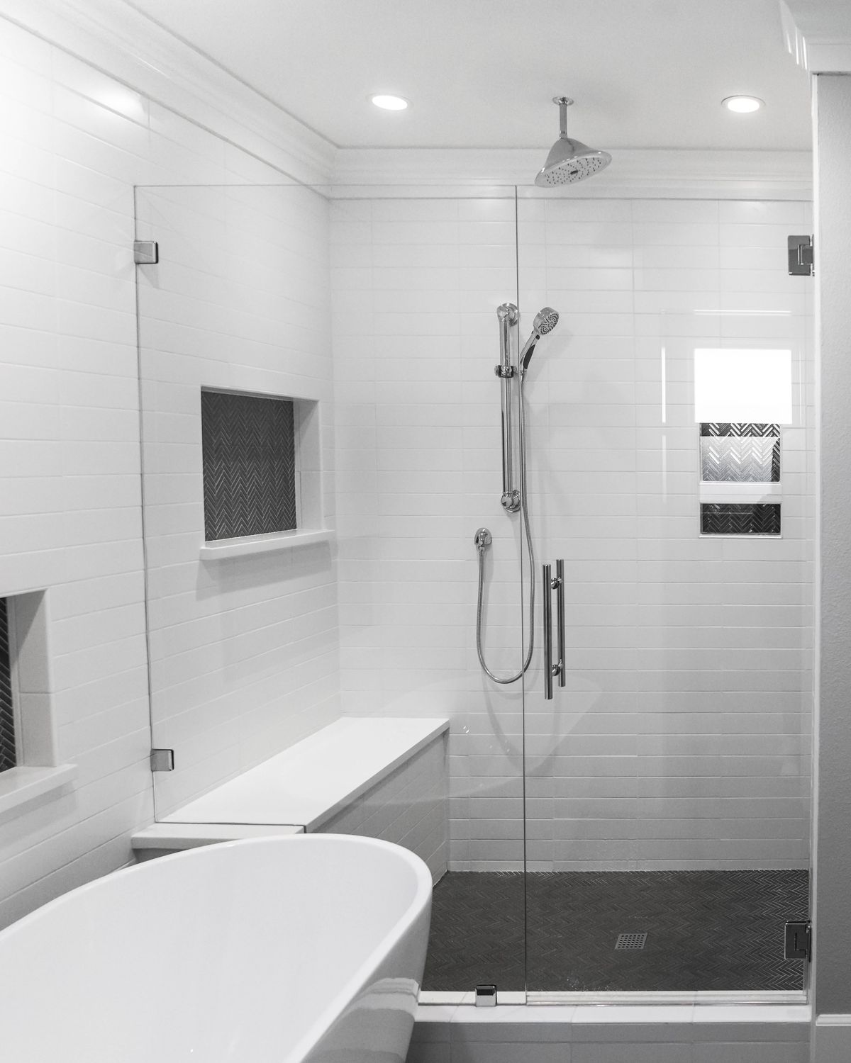 Freestanding tub beside a glass shower