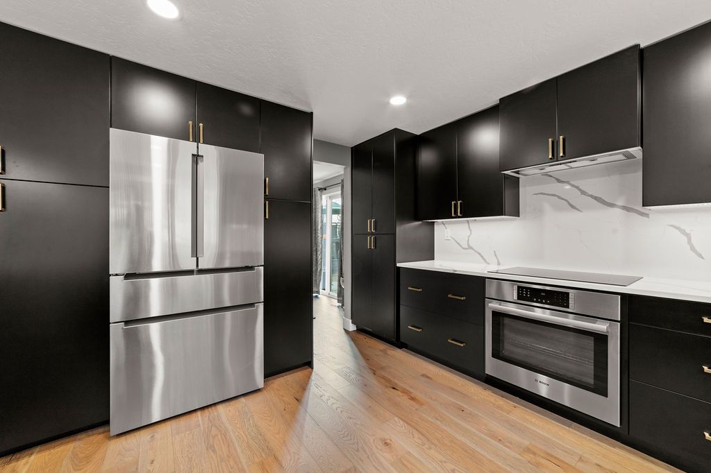 Custom built-in refrigerator wall with matching black panels