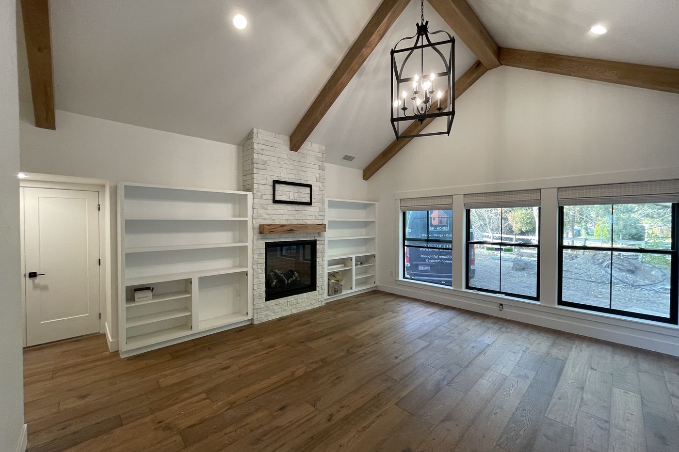 Master bedroom with vaulted butternut beams and fireplace